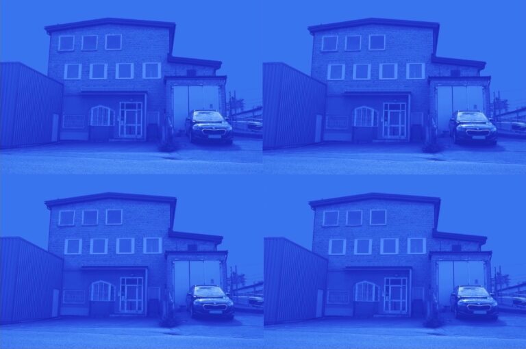 Office building with a car to the right infront of the garage. Picture is in white and blue